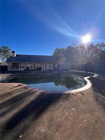 a view of a swimming pool with a yard