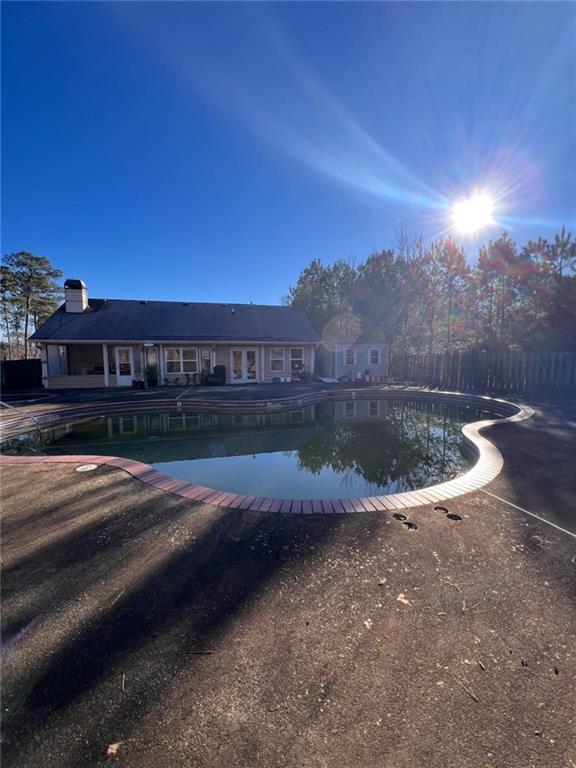 1401 Stone Bridge Lane Conyers, GA 30094 - Photo 24 of 27 a view of a swimming pool with a yard