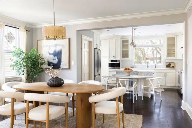a very nice looking dining room with kitchen island granite countertop a table and a chairs