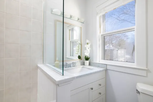 a bathroom with a granite countertop sink mirror and a