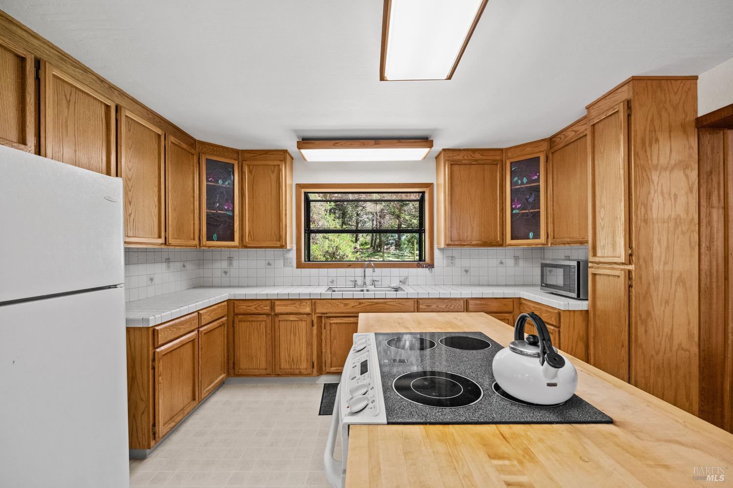 46320 Iversen Road Gualala, CA 95445 - Photo 12 of 46 a kitchen with stainless steel appliances granite countertop a sink and a refrigerator