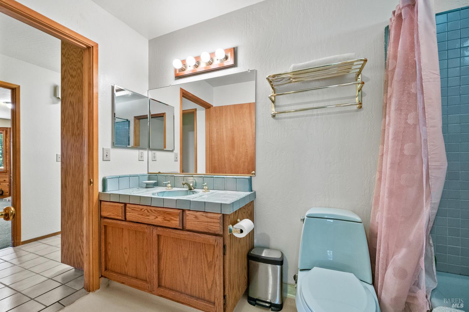 46320 Iversen Road Gualala, CA 95445 - Photo 26 of 46 a bathroom with a granite countertop toilet sink and mirror