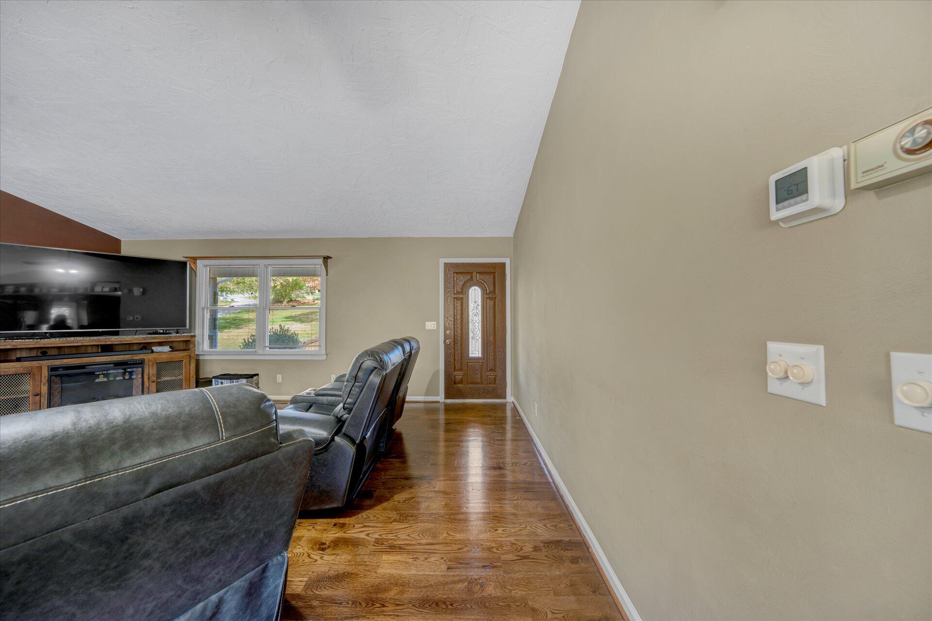 1041 Owen Ridge Lane Goodview, VA 24095 - Photo 12 of 58 a living room with furniture and a flat screen tv