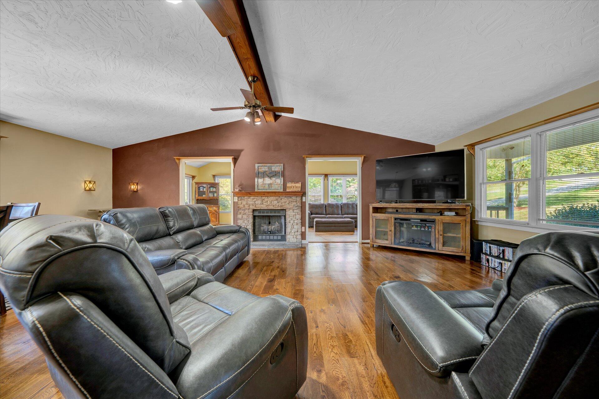1041 Owen Ridge Lane Goodview, VA 24095 - Photo 13 of 58 a living room with furniture ceiling fan and a flat screen tv