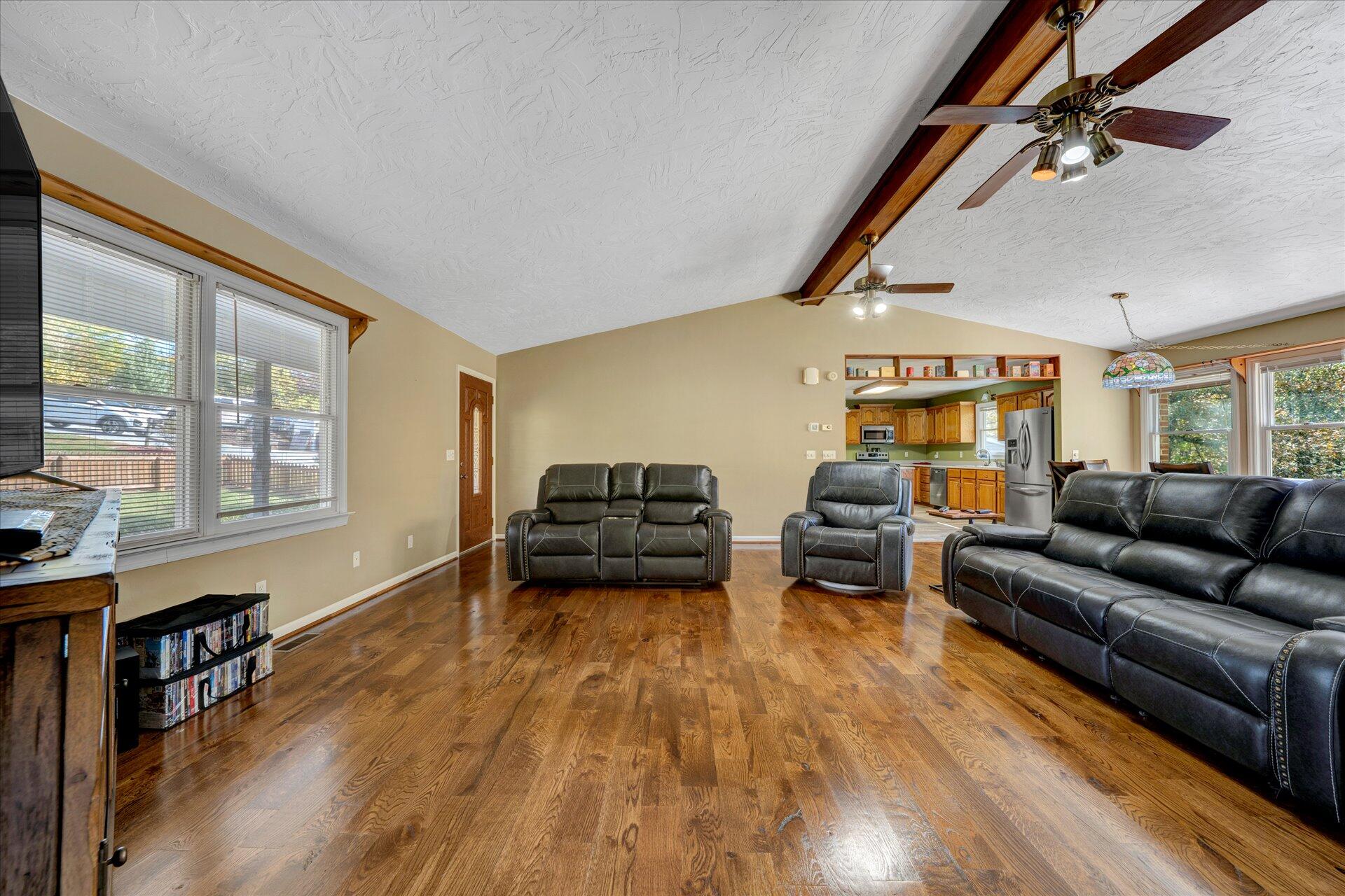 1041 Owen Ridge Lane Goodview, VA 24095 - Photo 15 of 58 a living room with furniture and a wooden floor