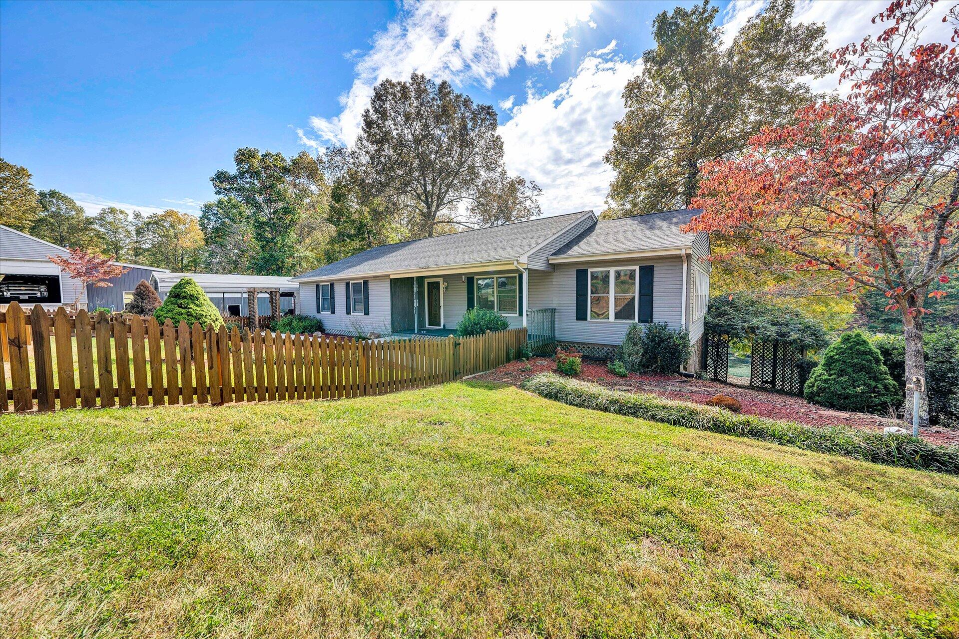 1041 Owen Ridge Lane Goodview, VA 24095 - Photo 2 of 58 a view of a house with a patio and a yard