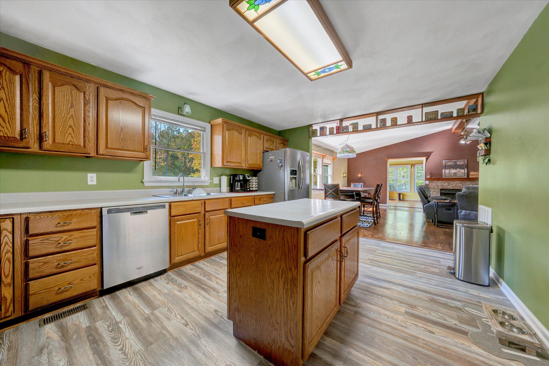 1041 Owen Ridge Lane Goodview, VA 24095 - Photo 22 of 58 a kitchen with wooden cabinets and a sink