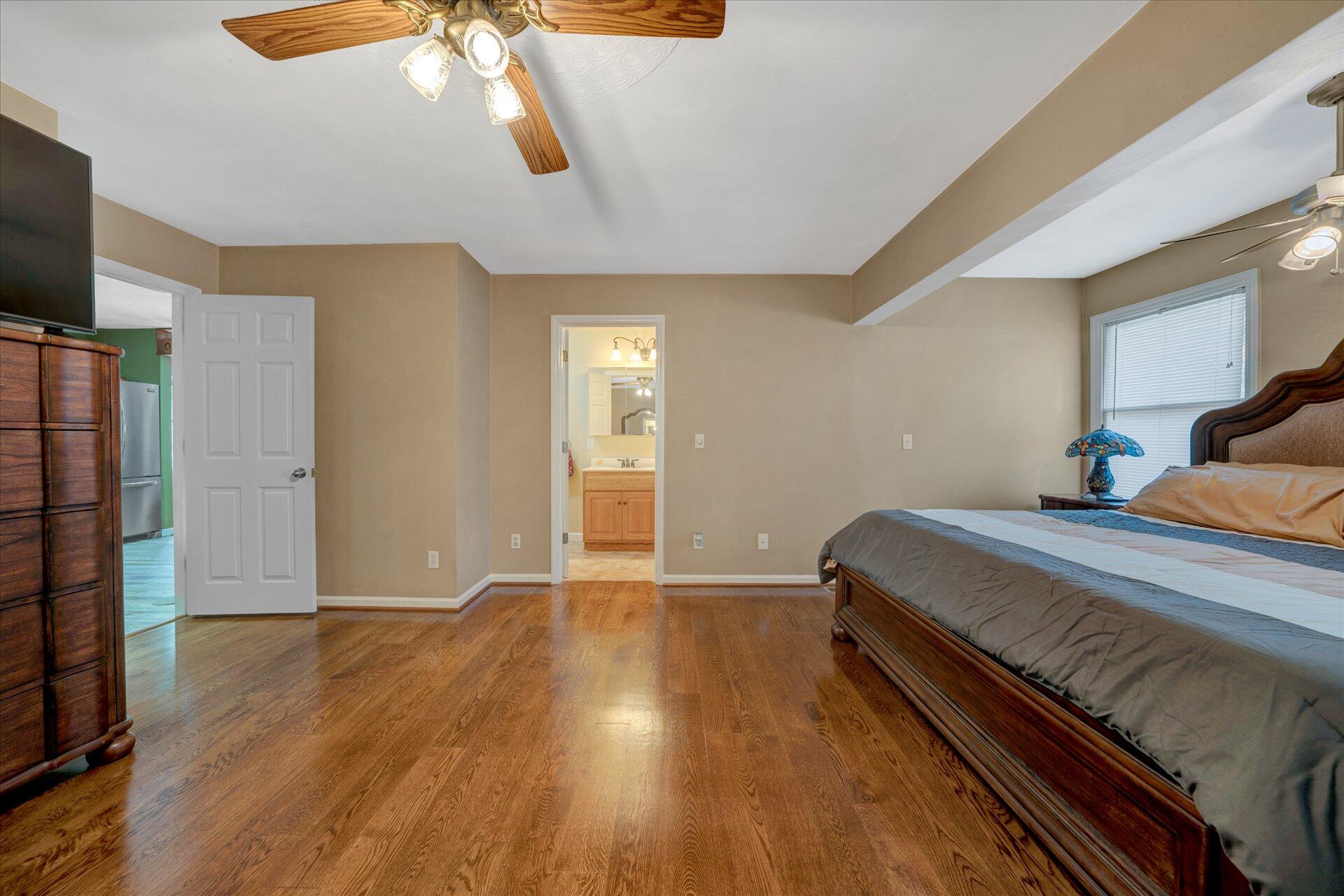 1041 Owen Ridge Lane Goodview, VA 24095 - Photo 24 of 58 a bedroom with a bed and a flat screen tv