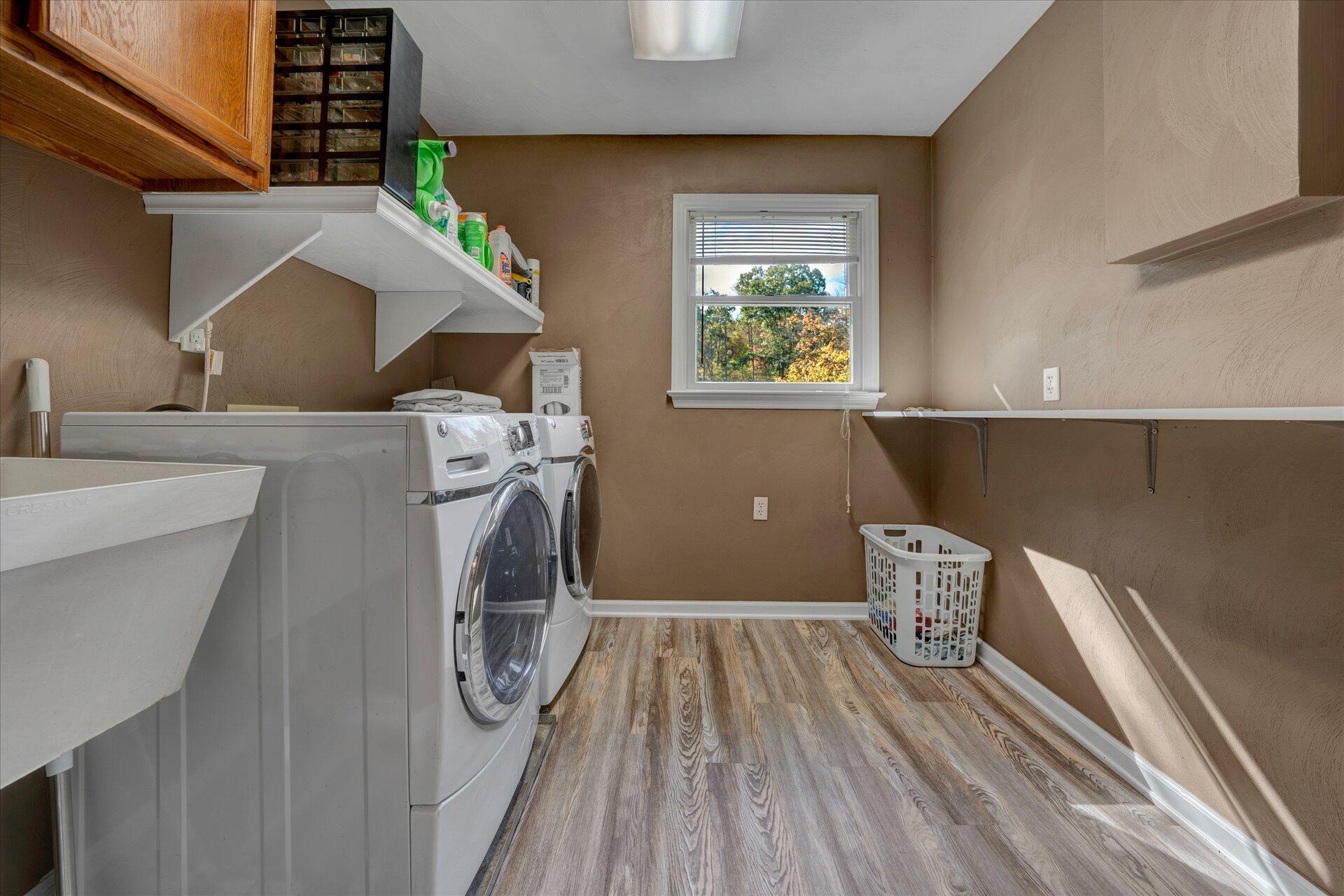 1041 Owen Ridge Lane Goodview, VA 24095 - Photo 27 of 58 a view of washer and dryer with kitchen in the background