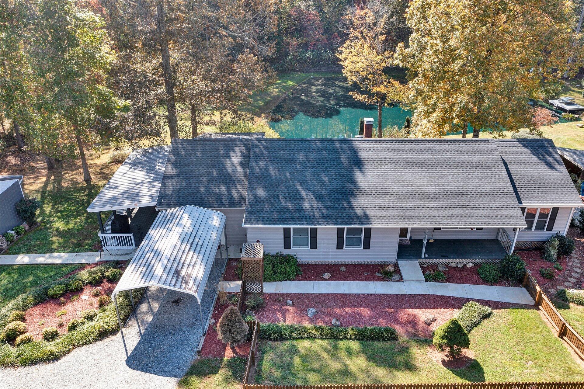 1041 Owen Ridge Lane Goodview, VA 24095 - Photo 3 of 58 a view of a patio with table and chairs potted plants and large tree