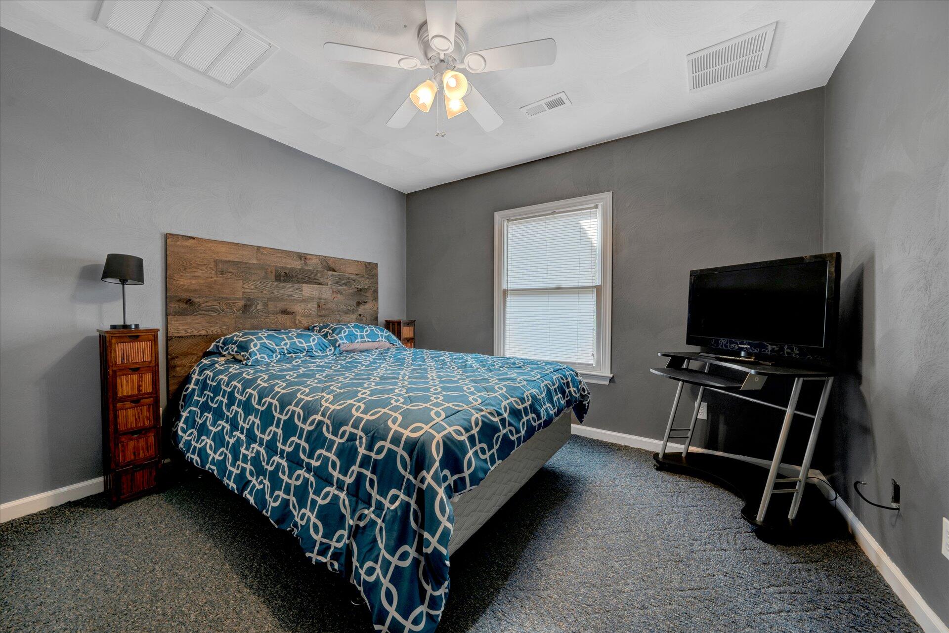 1041 Owen Ridge Lane Goodview, VA 24095 - Photo 36 of 58 a bedroom with a bed and a flat tv screen on the dresser