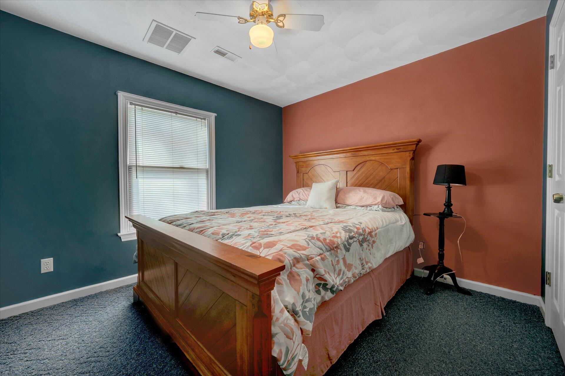 1041 Owen Ridge Lane Goodview, VA 24095 - Photo 37 of 58 a bed sitting in a bedroom next to a window