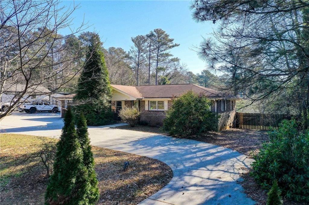 1405 Dillon Road Austell, GA 30168 - Photo 3 of 32 a front view of a house with a yard and tree s