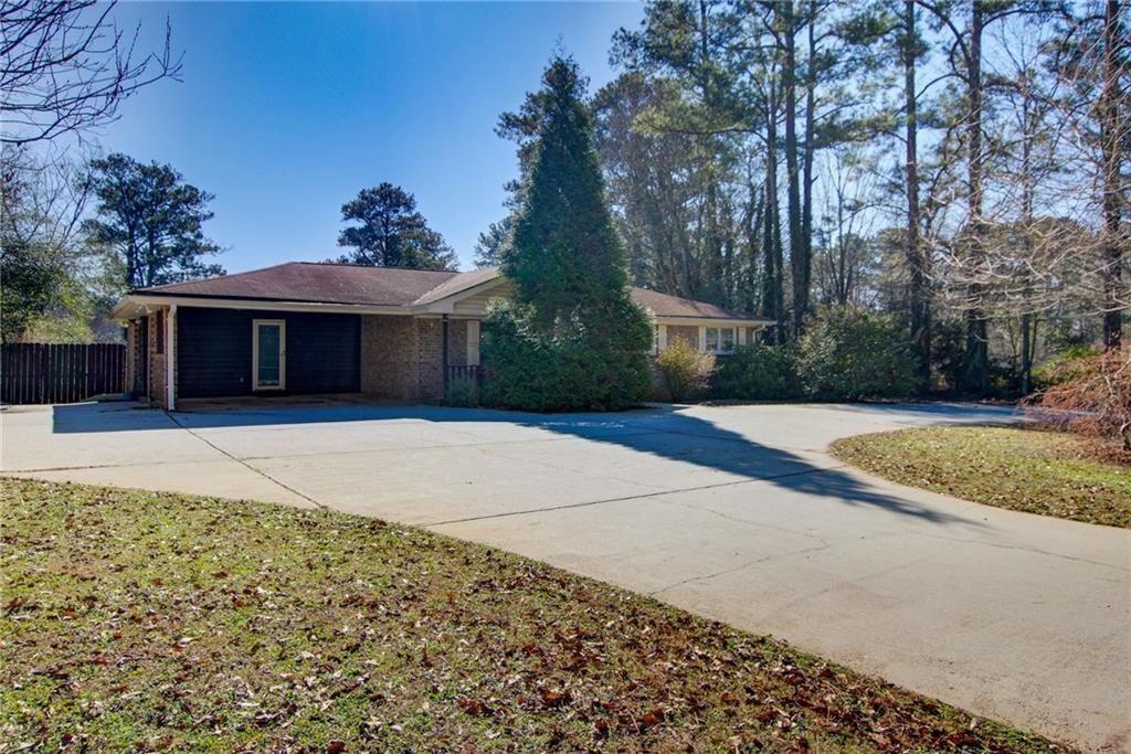 1405 Dillon Road Austell, GA 30168 - Photo 4 of 32 a house with trees in front of it