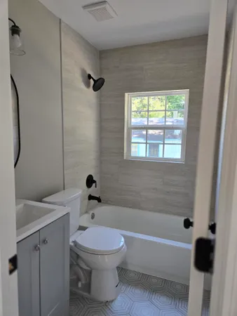a bathroom with a sink a toilet and a bathtub