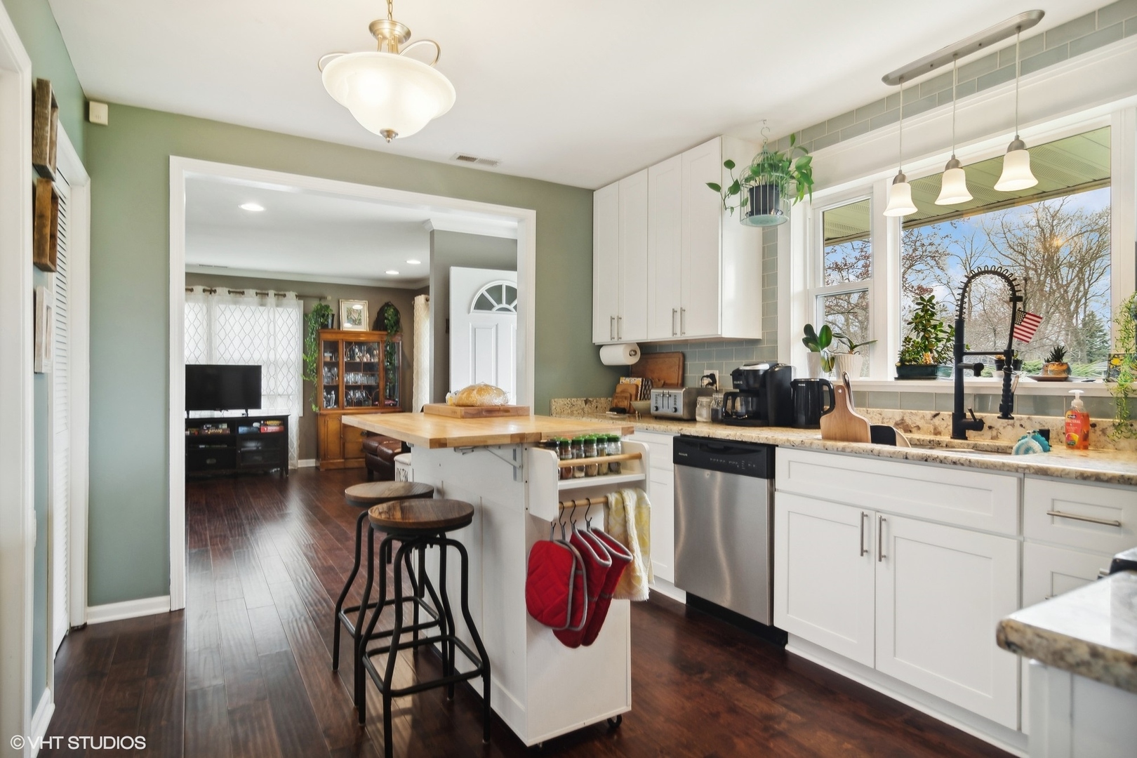 11 Rugby Road Lake Zurich, IL 60047 - Photo 8 of 25 a kitchen with kitchen island granite countertop wooden floors and sink