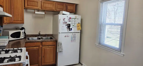 a kitchen with stainless steel appliances granite countertop a refrigerator and a stove