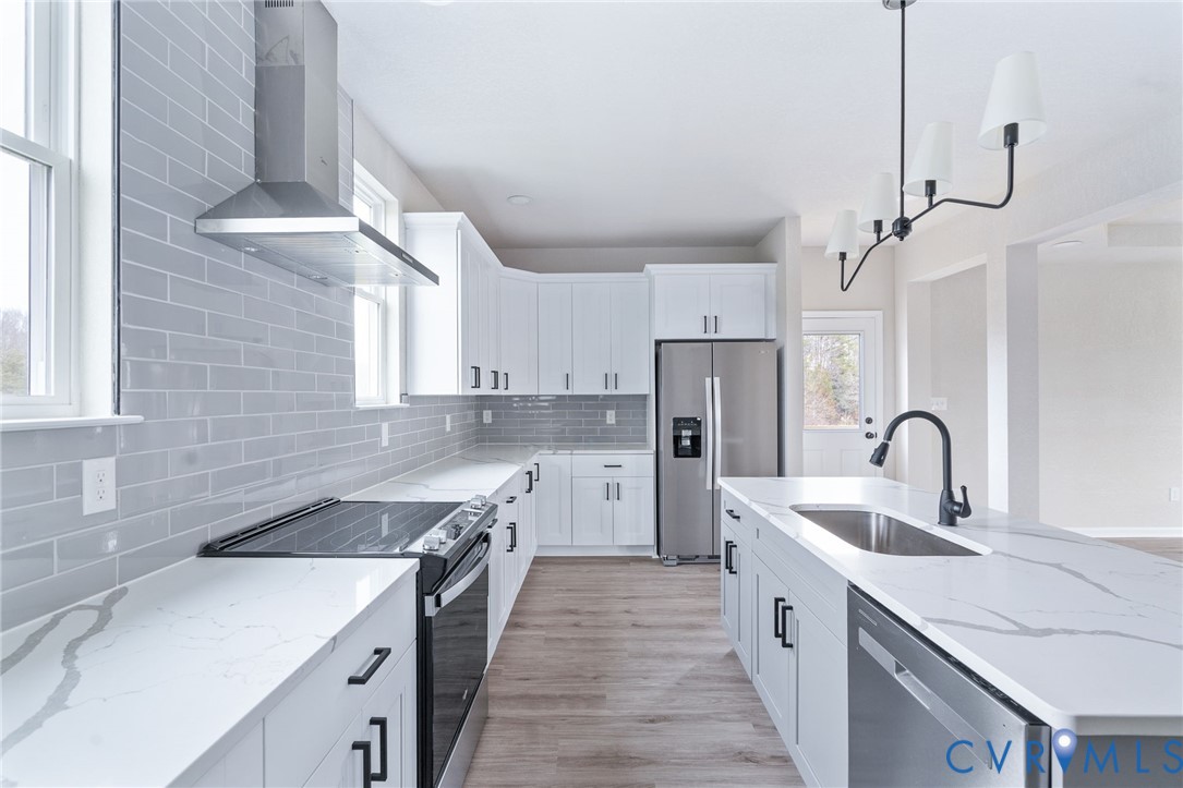63 Hatcher Road Powhatan, VA 23139 - Photo 21 of 48 a kitchen with a sink a counter top space cabinets and stainless steel appliances