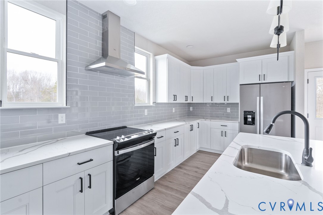 63 Hatcher Road Powhatan, VA 23139 - Photo 23 of 48 a kitchen with granite countertop a sink stainless steel appliances and window