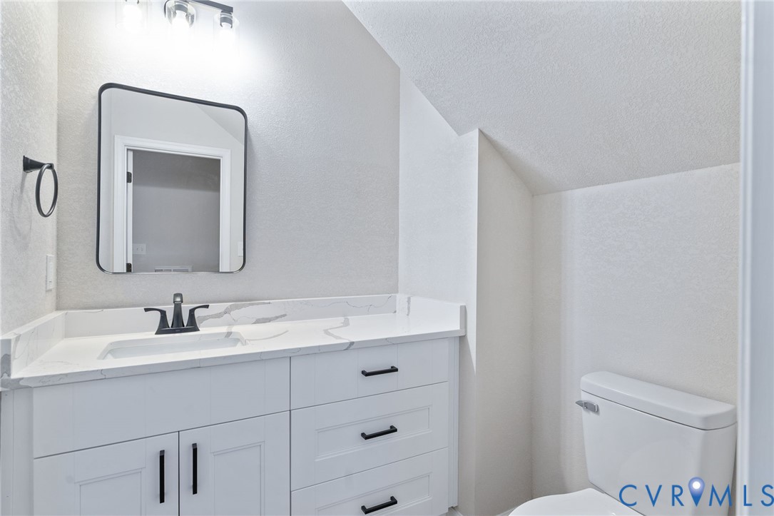 63 Hatcher Road Powhatan, VA 23139 - Photo 25 of 48 a bathroom with a toilet sink and mirror