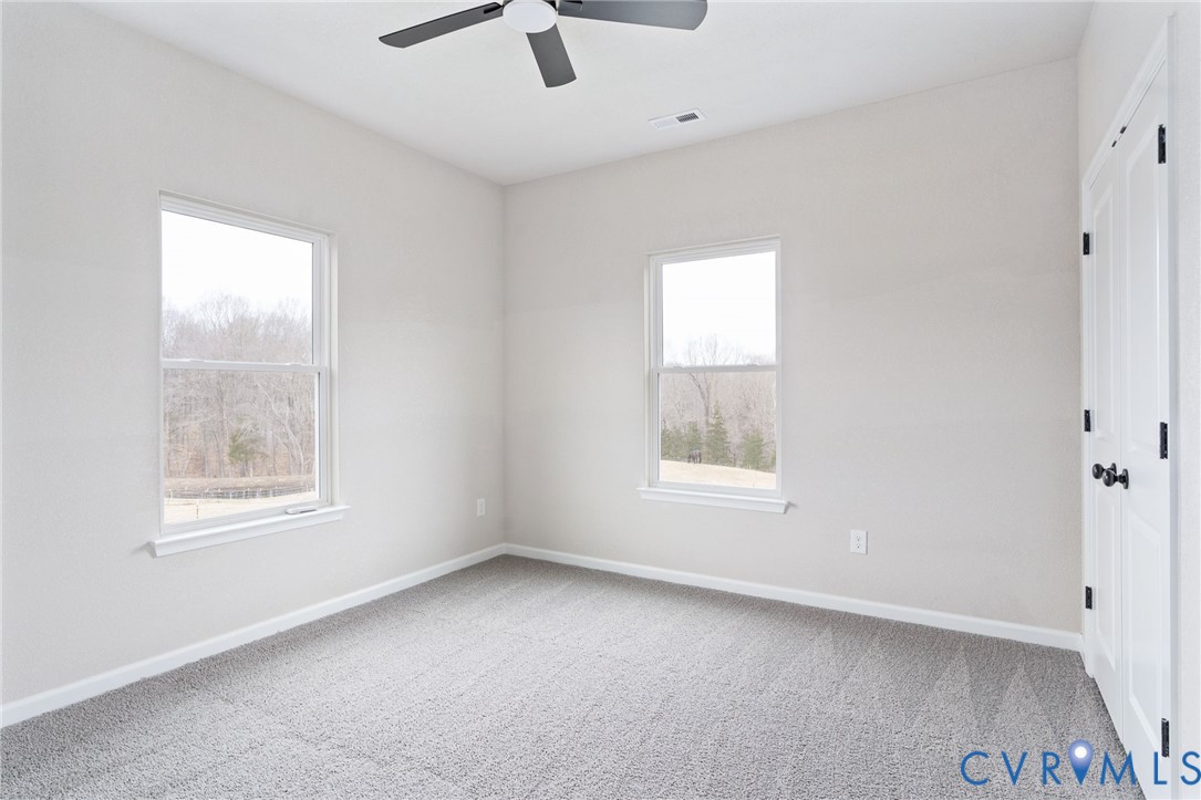 63 Hatcher Road Powhatan, VA 23139 - Photo 34 of 48 an empty room with a window and a ceiling fan