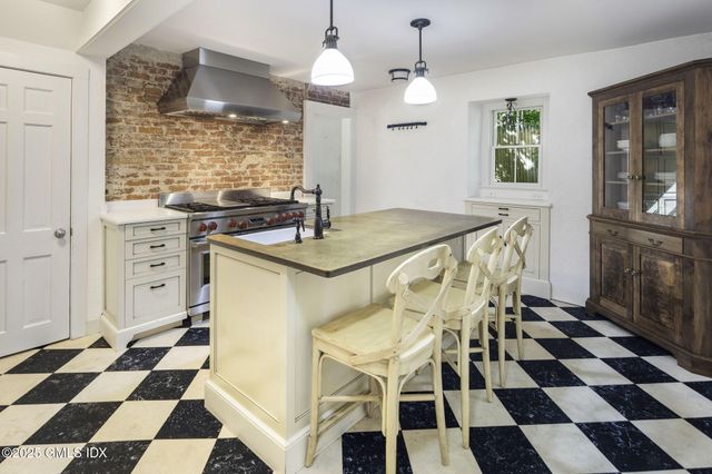 a kitchen with a sink a stove and cabinets