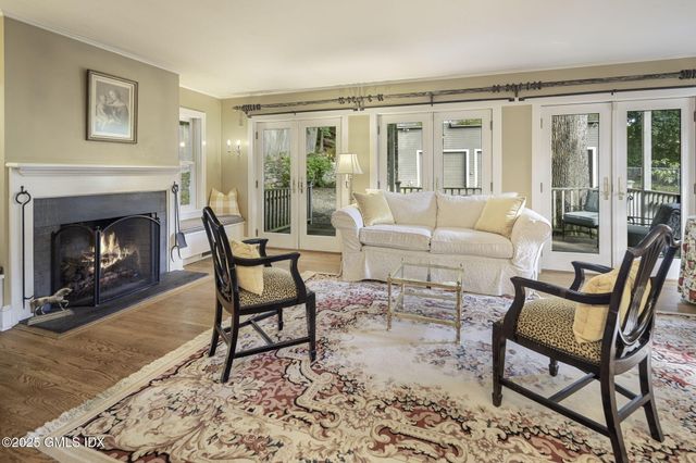 a living room with furniture a fireplace and a table