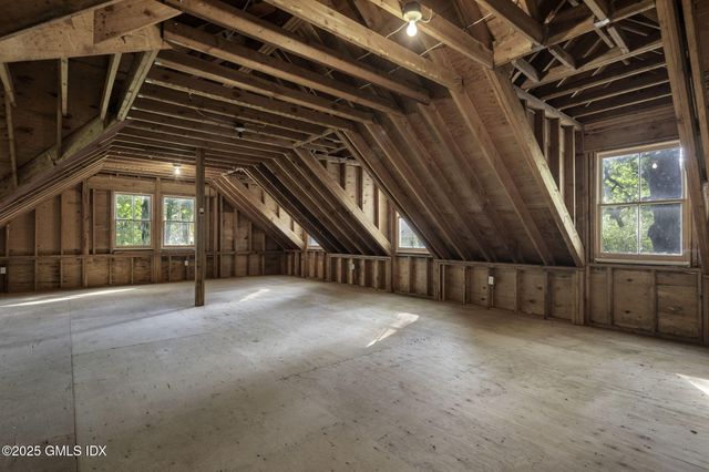 a picture of a bench in front of a wall