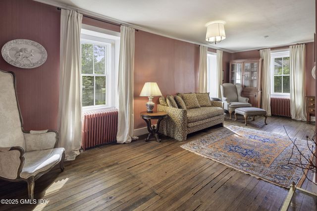 a living room with furniture a window and a table