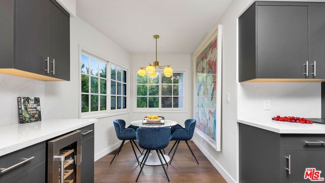 a balcony with dining table and chairs