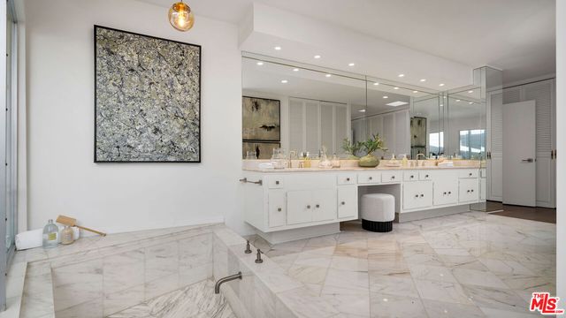 a bathroom with a sink a vanity and a mirror