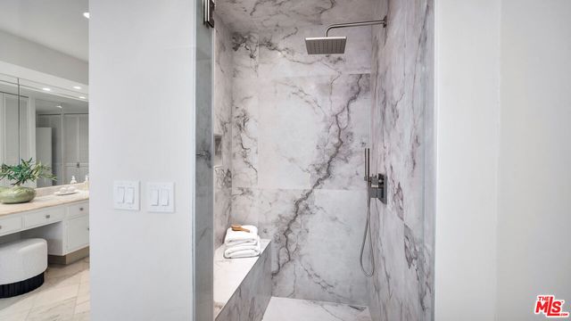 a bathroom with a granite countertop shower curtain and a sink