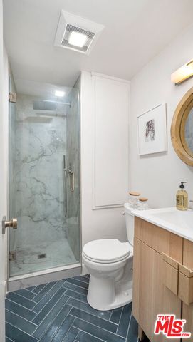 a bathroom with a toilet a sink and shower
