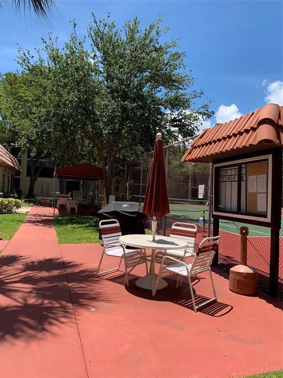 259 South Cypress Road, Unit 533 Pompano Beach, FL 33060 - Photo 12 of 19 a view of backyard with swimming pool and furniture