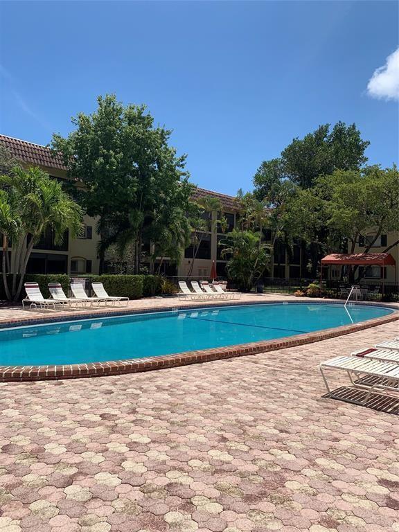 259 South Cypress Road, Unit 533 Pompano Beach, FL 33060 - Photo 14 of 19 a view of swimming pool with trees