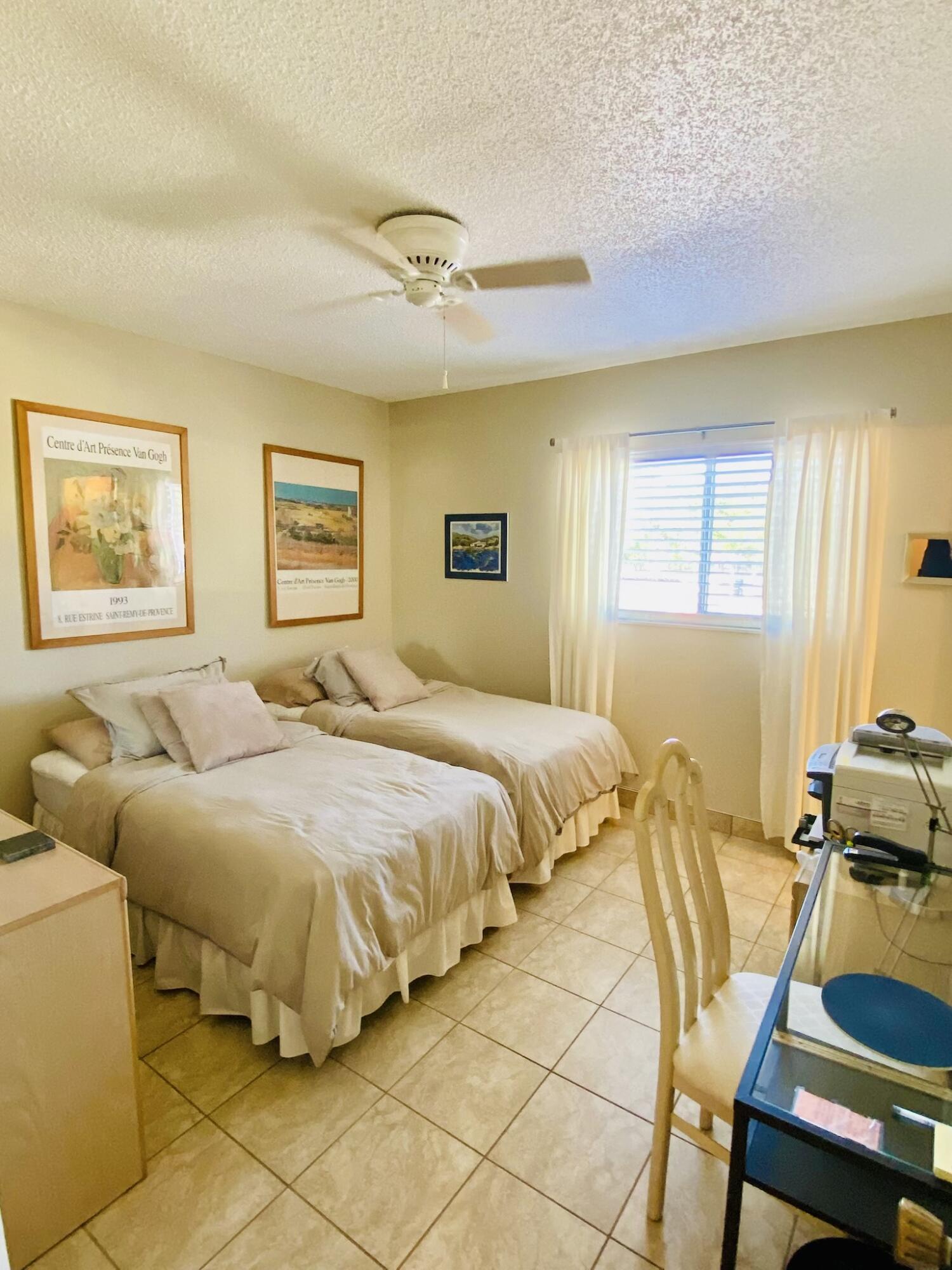 259 South Cypress Road, Unit 533 Pompano Beach, FL 33060 - Photo 3 of 19 a bedroom with a bed and wooden floor