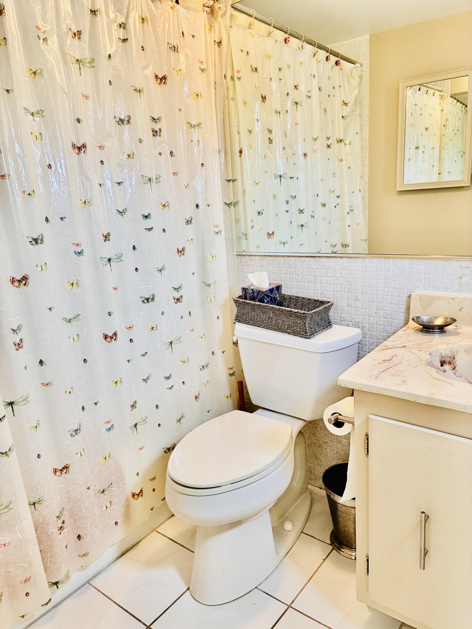 259 South Cypress Road, Unit 533 Pompano Beach, FL 33060 - Photo 5 of 19 a white toilet sitting next to a shower curtain