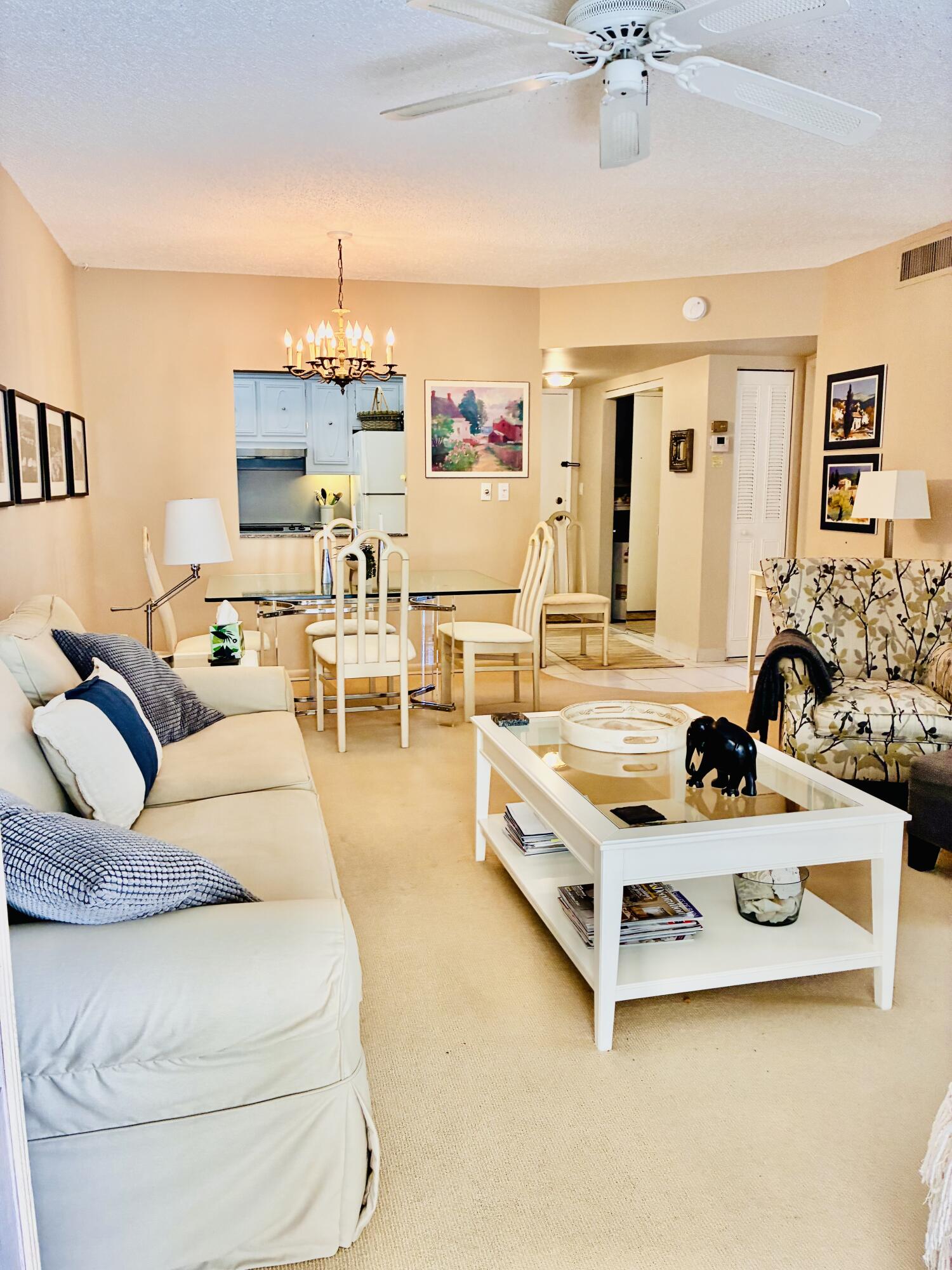 259 South Cypress Road, Unit 533 Pompano Beach, FL 33060 - Photo 8 of 19 a living room with furniture and a chandelier