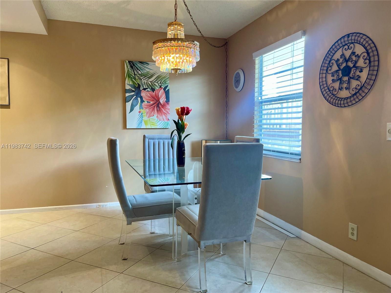2042 Newcastle A, Unit 2042 Boca Raton, FL 33434 - Photo 5 of 17 a view of a dining room with furniture and a chandelier