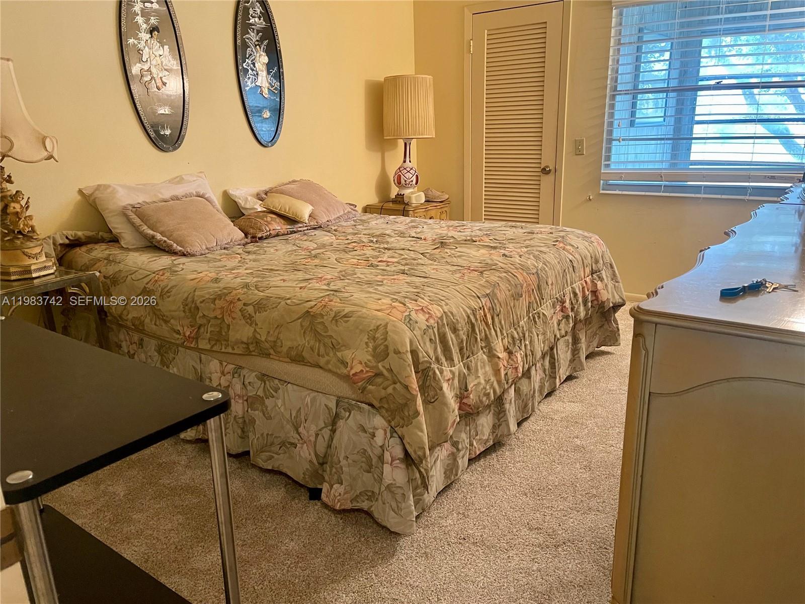 2042 Newcastle A, Unit 2042 Boca Raton, FL 33434 - Photo 6 of 17 a bedroom with a bed and a window