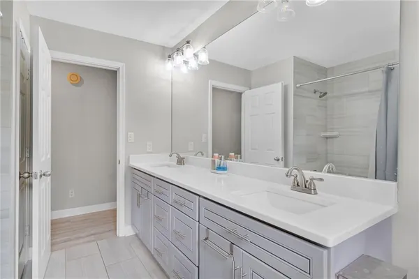 a bathroom with a sink double vanity and a mirror