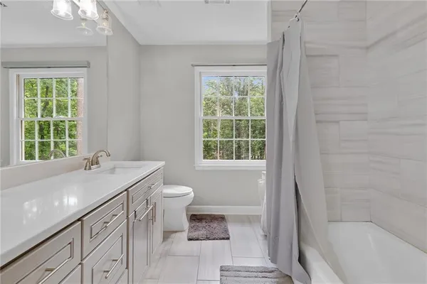 a bathroom with a sink toilet and bathtub