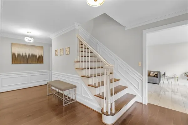 a view of entryway with wooden floor and front door