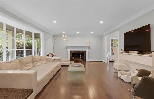 a living room with furniture fireplace and flat screen tv