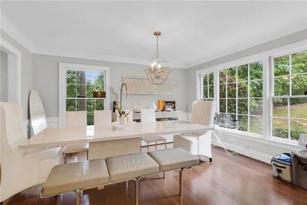 a very nice looking dining room with a large window and dining table