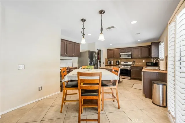a dining room with furniture and kitchen view