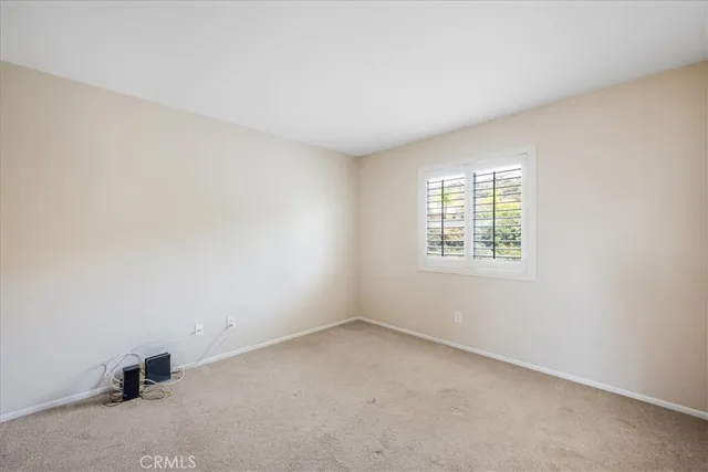 a bedroom with bed and window