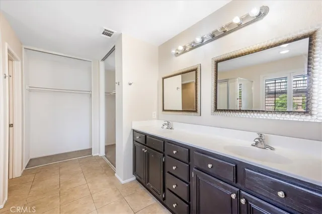 a bathroom with a sink and two mirror
