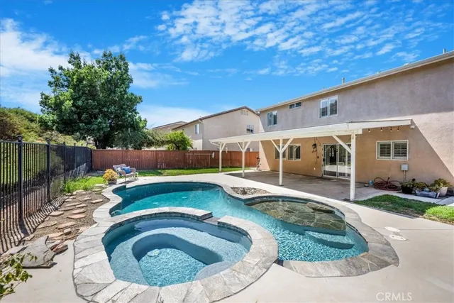 a swimming pool with outdoor seating and yard