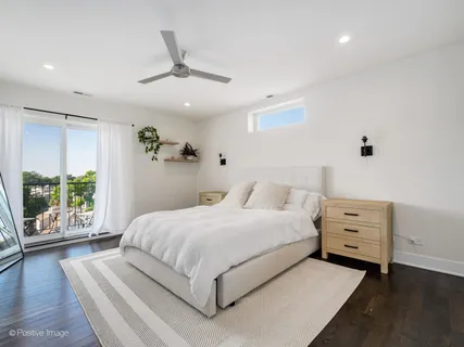 a bedroom with a large bed and a large window